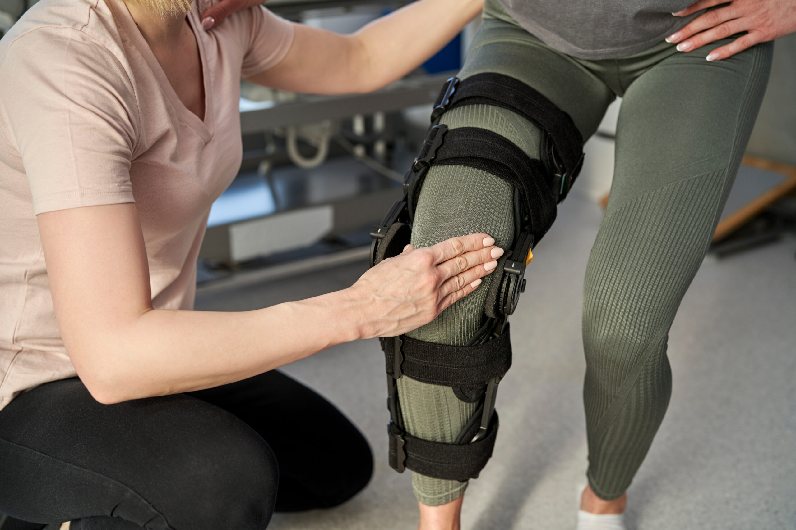 Woman with orthosis working with physical therapist