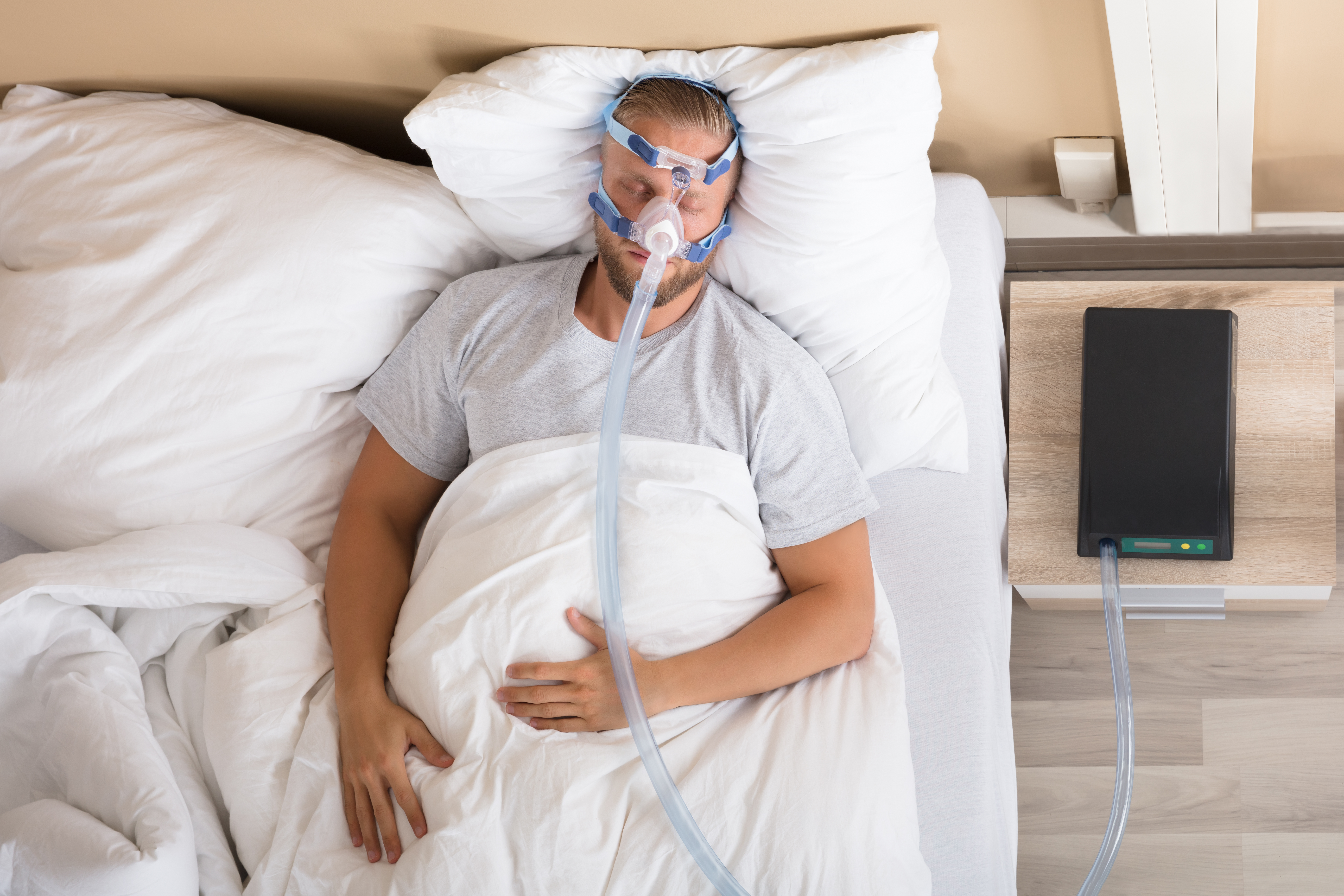 Man sleeping with CPAP device on face