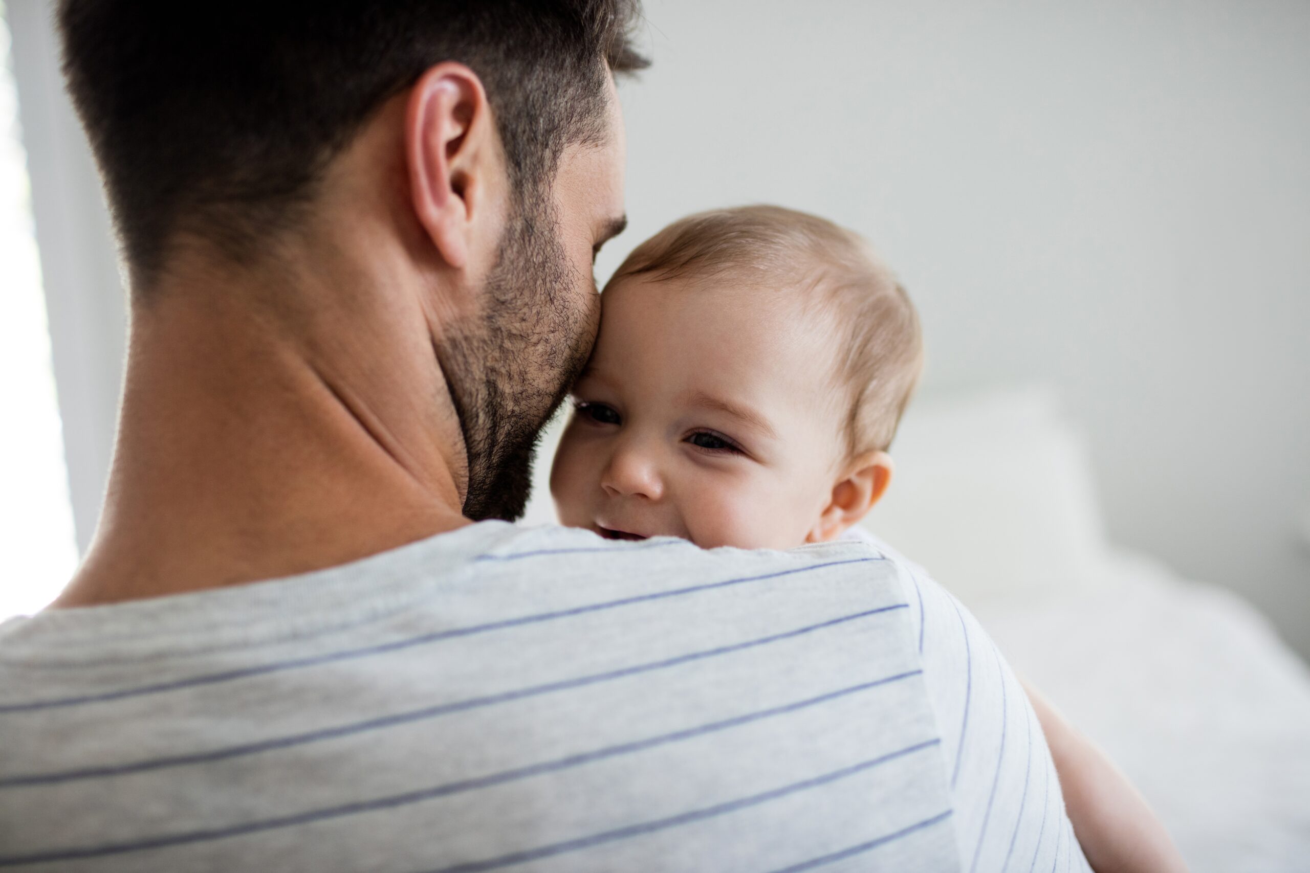 Dad cuddling with baby son