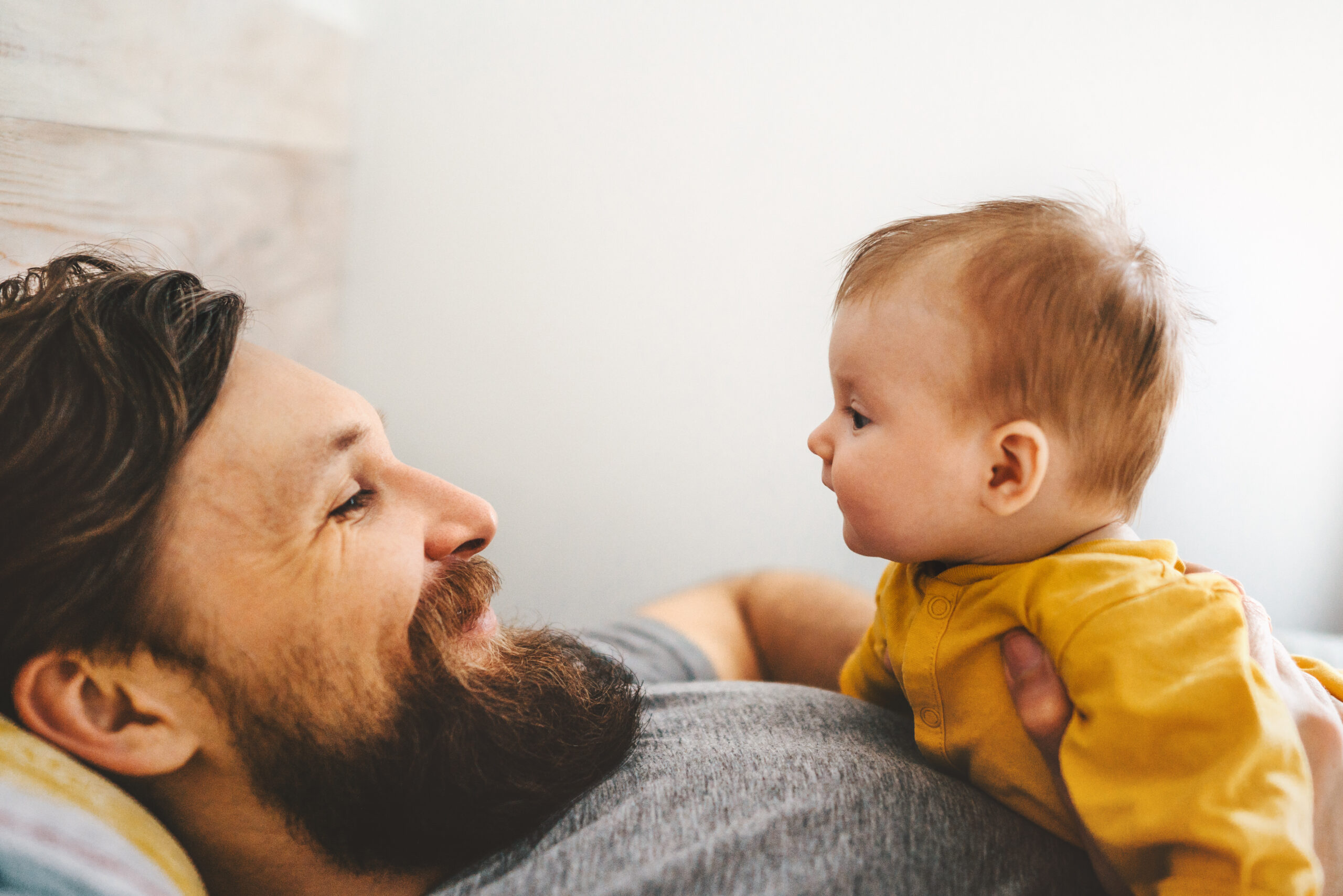 Father and baby daughter playing together