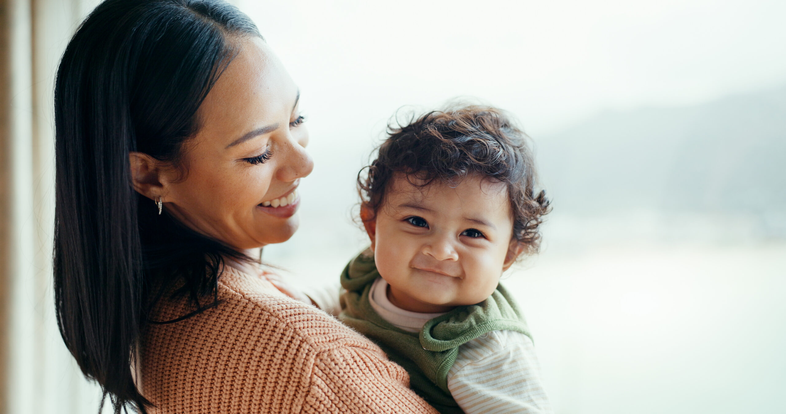 Mum holding smiling baby