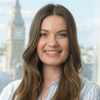 Woman with long brown hair smiling for professional headshot