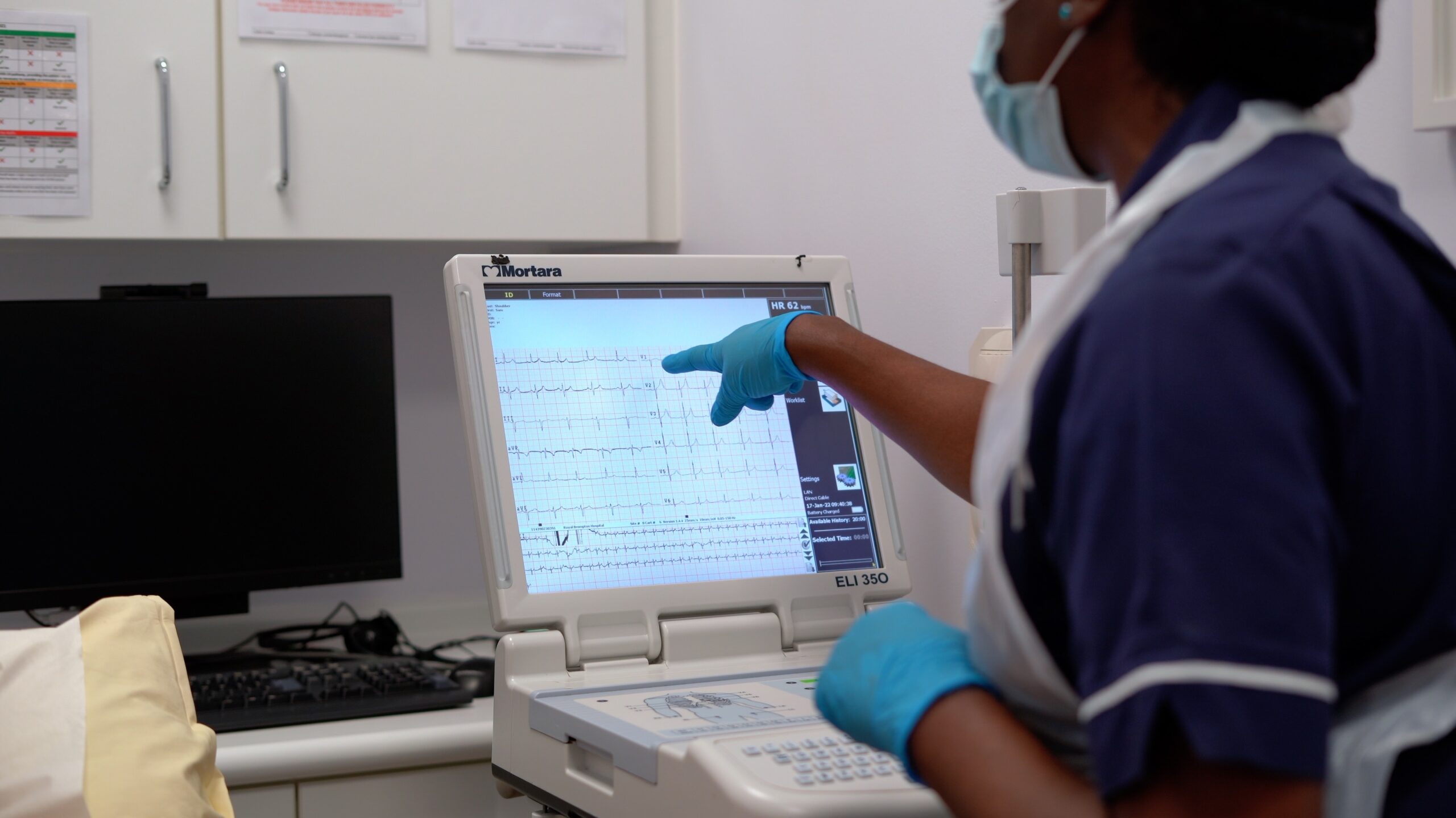 Staff member carrying out ECG (electrocardiogram)