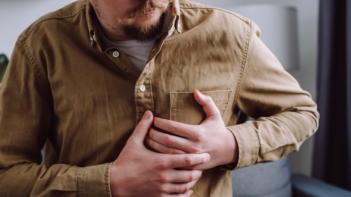 Man clutching chest