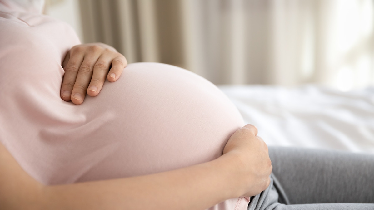 Pregnant woman lying on a bed