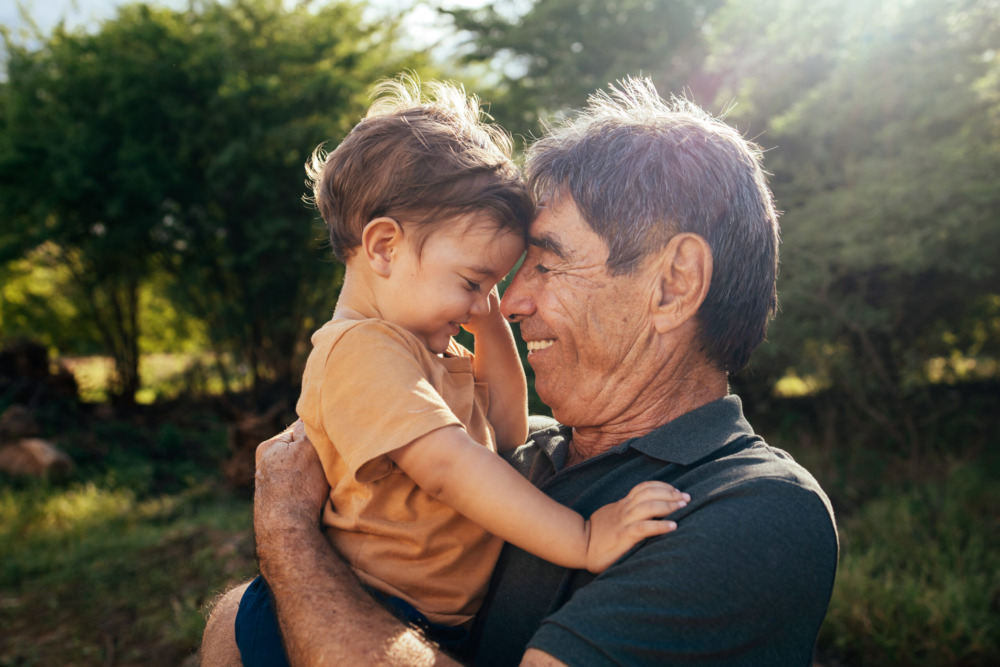 Grandfather spending time with his grandson in park