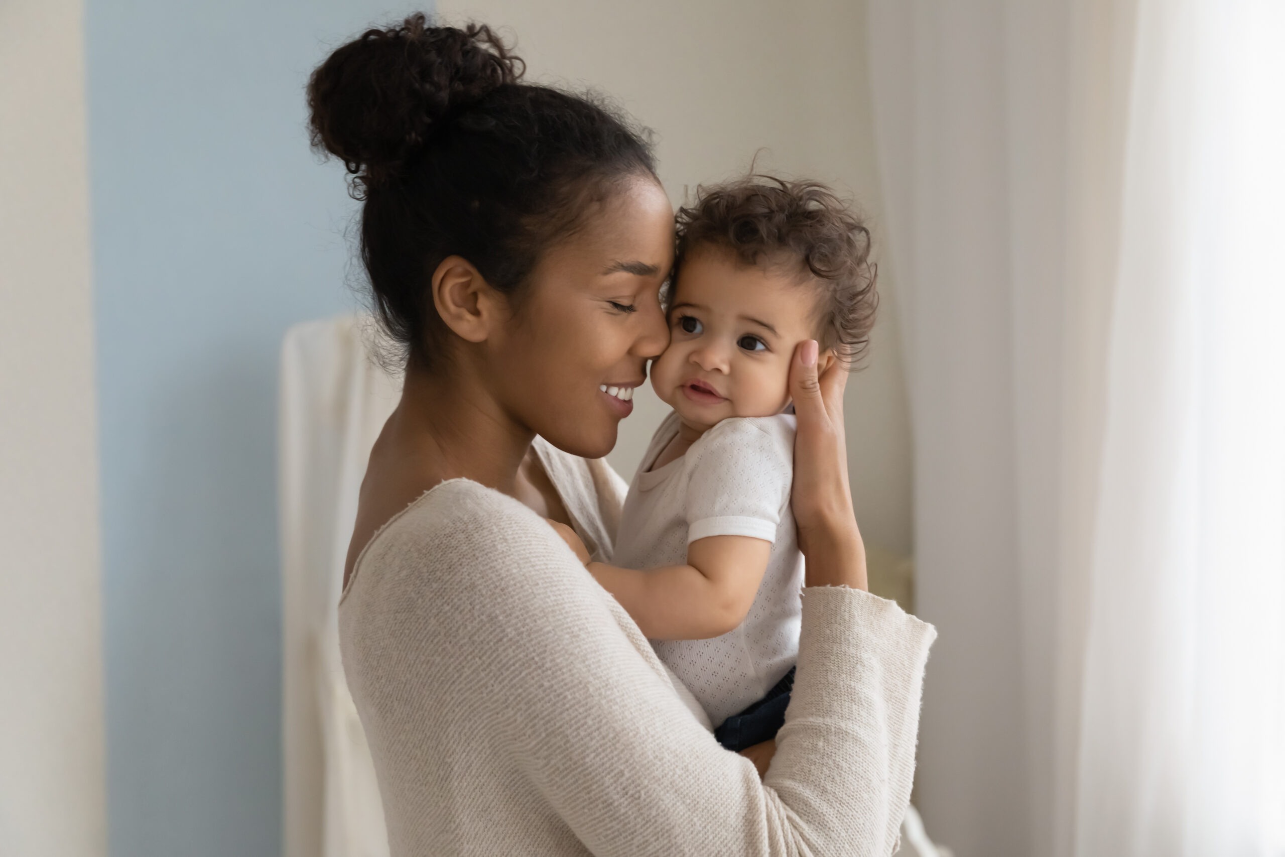 Happy mom embrace little baby toddler